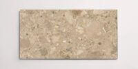 A single brown terrazzo marble tile with various sized aggregates throughout