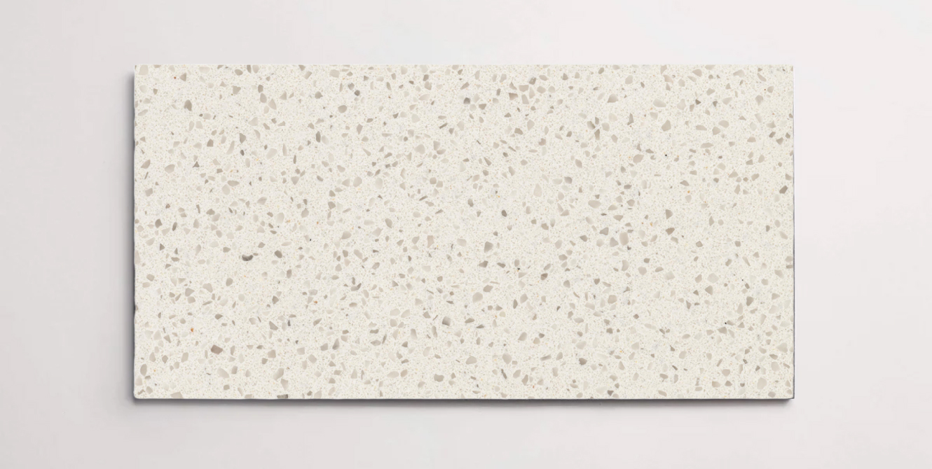 A single cream terrazzo marble tile with small taupe colored chips throughout
