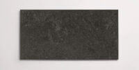 A single black terrazzo marble tile with subtle aggregates throughout
