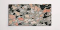A single light green terrazzo marble tile with various sized multicolor aggregates throughout