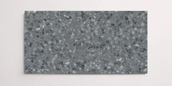 A single dark grey terrazzo marble tile with small aggregates throughout