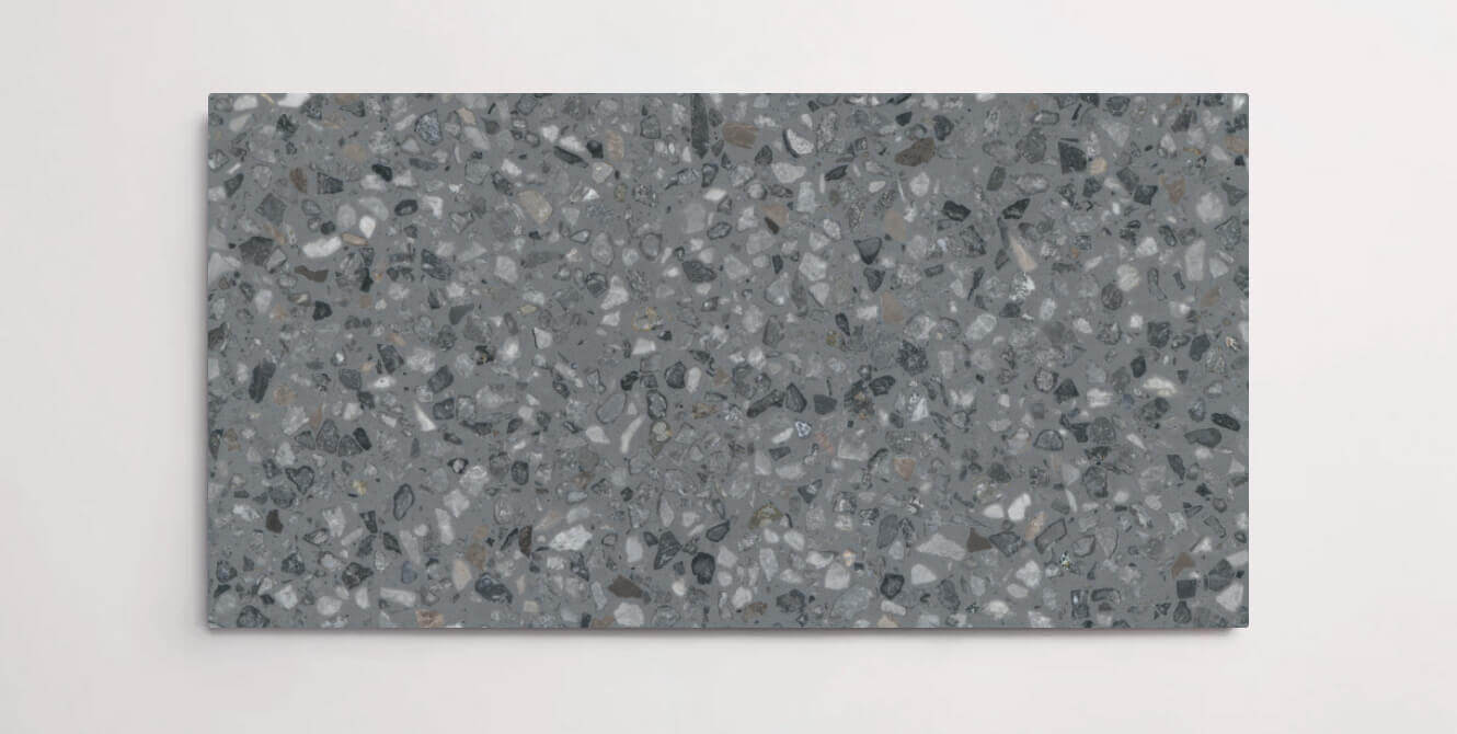 A single dark grey terrazzo marble tile with small aggregates throughout
