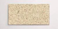 A single beige colored terrazzo marble tile with various sized chips throughout