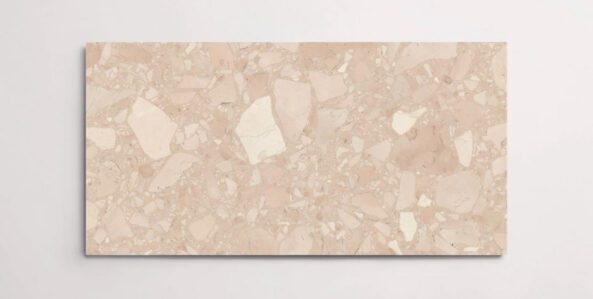 A single blush colored terrazzo marble tile with various sized aggregates throughout