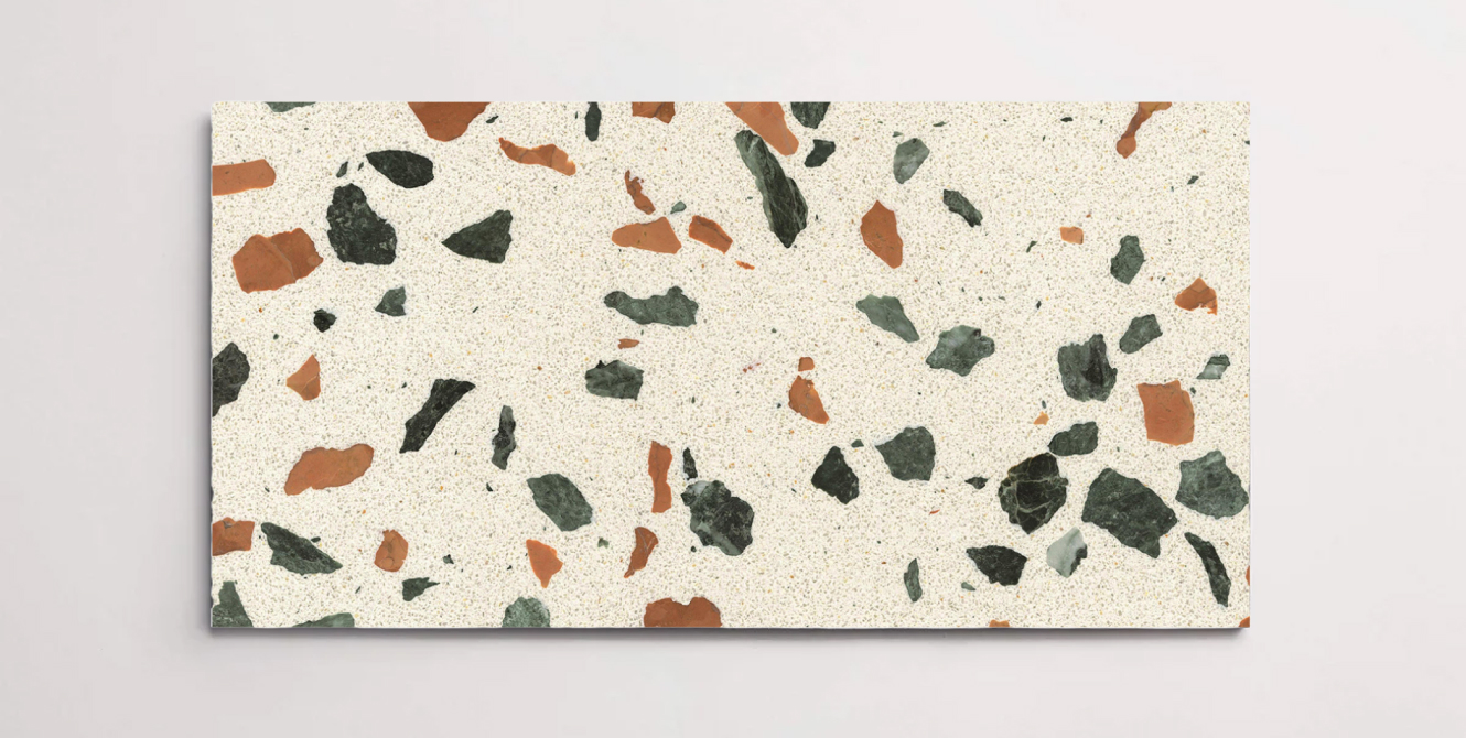 A single cream terrazzo marble tile with various sized multicolor chips throughout