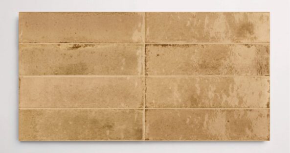 Eight stacked 2.25" x 9.5" beige wall tiles in a glossy finish