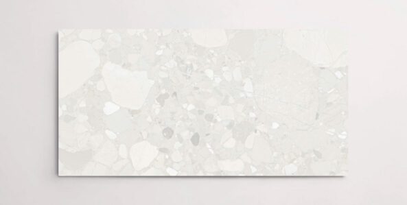 A single white and grey porcelain tile with a terrazzo marble look