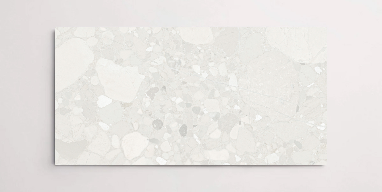 A single white and grey porcelain tile with a terrazzo marble look