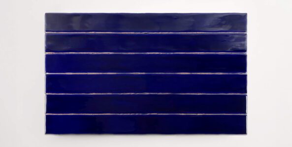 Six stacked 2" x 20" deep blue ceramic tiles in a glossy finish