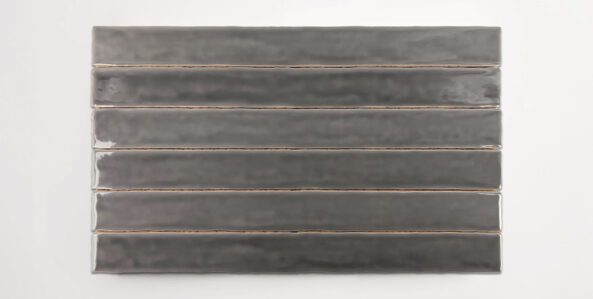 Six stacked 2" x 20" dark grey ceramic tiles in a glossy finish