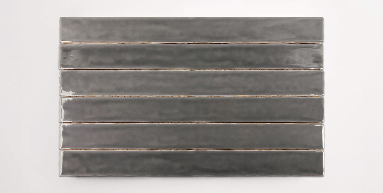 Six stacked 2" x 20" dark grey ceramic tiles in a glossy finish