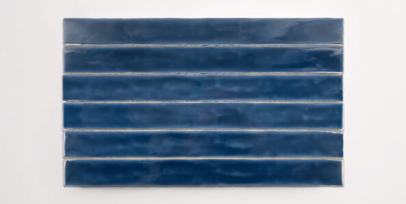 Six stacked 2" x 20" ceramic tiles in a dark blue color