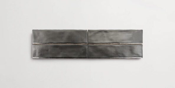 Four stacked 2" x 10" metallic silver ceramic tiles