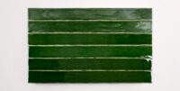 Six stacked 2" x 20" ceramic tiles in a deep green color
