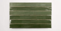 Six stacked 2" x 20" ceramic tiles in a dark green color
