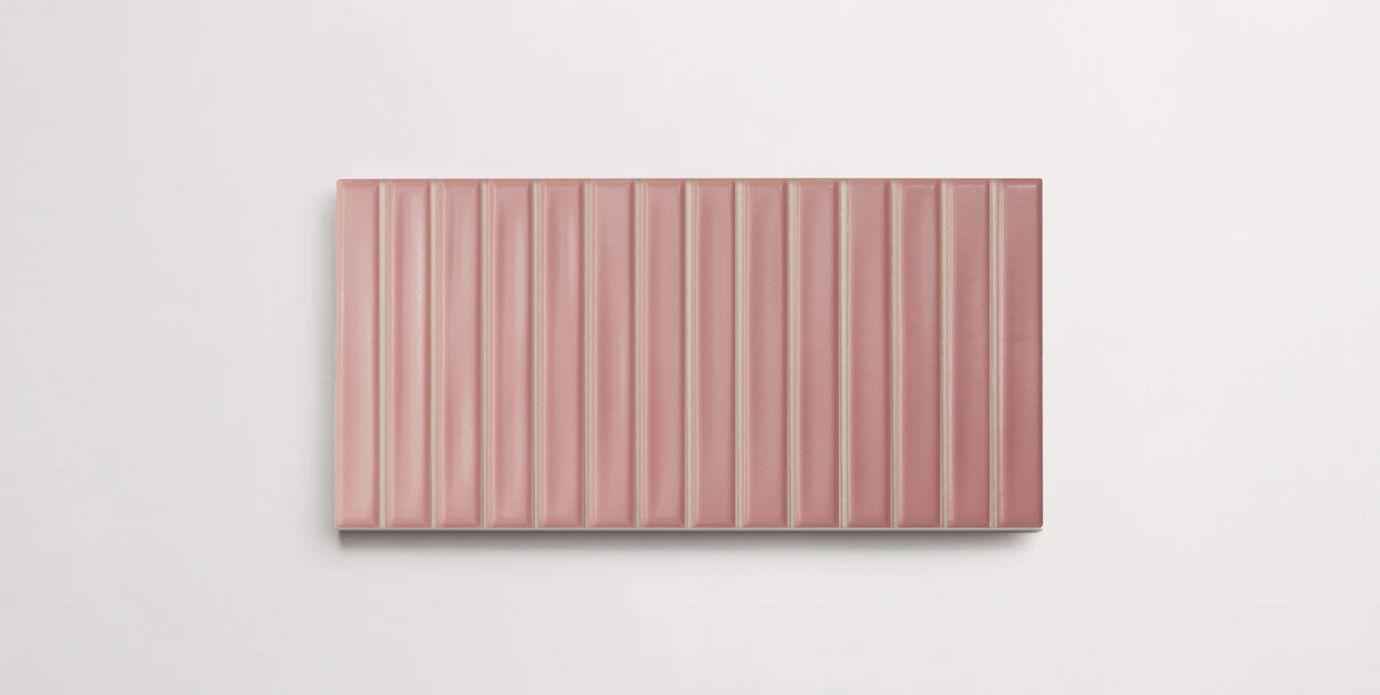 A single blush colored porcelain tile in a matte finish
