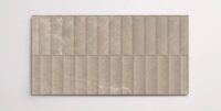 A single brown 10" x 30" porcelain tile resembling stone with a textured blind pattern and subtle veining
