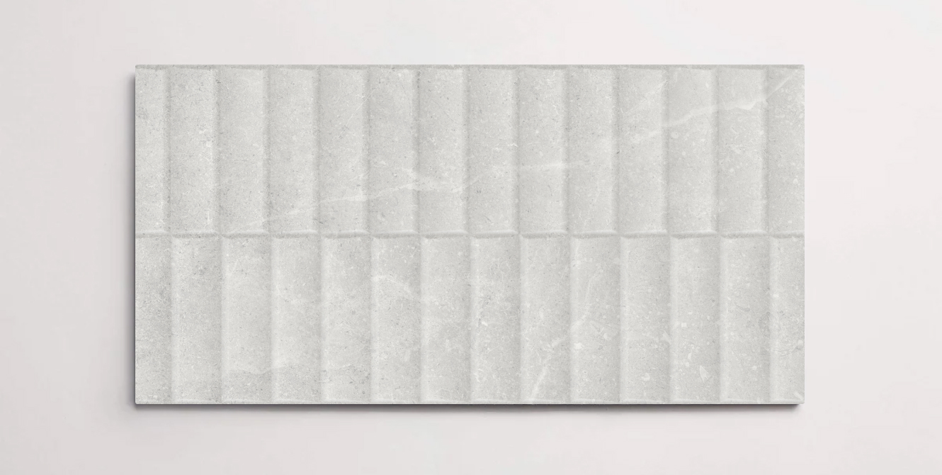 A single white 10" x 30" stone-like porcelain tile with a textured blind pattern and subtle veining