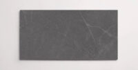 A single dark grey 10" x 30" stone-like porcelain tile with subtle veining