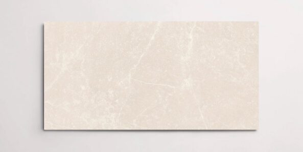 A single cream colored 10" x 30" stone-like porcelain tile with subtle veining