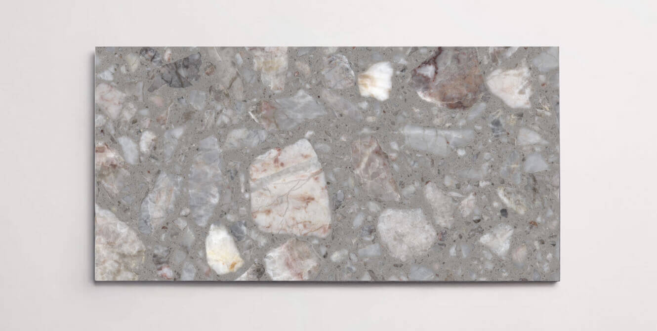 A single grey terrazzo marble tile with various sized aggregates throughout