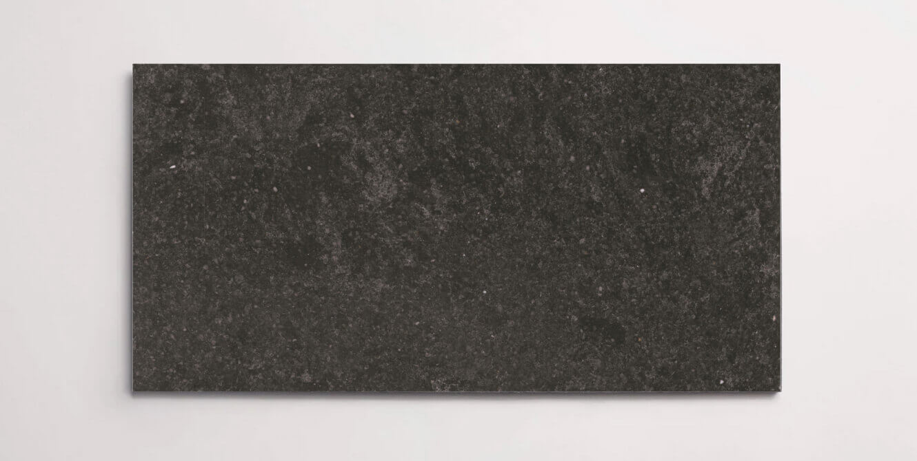 A single black terrazzo marble tile with subtle aggregates throughout