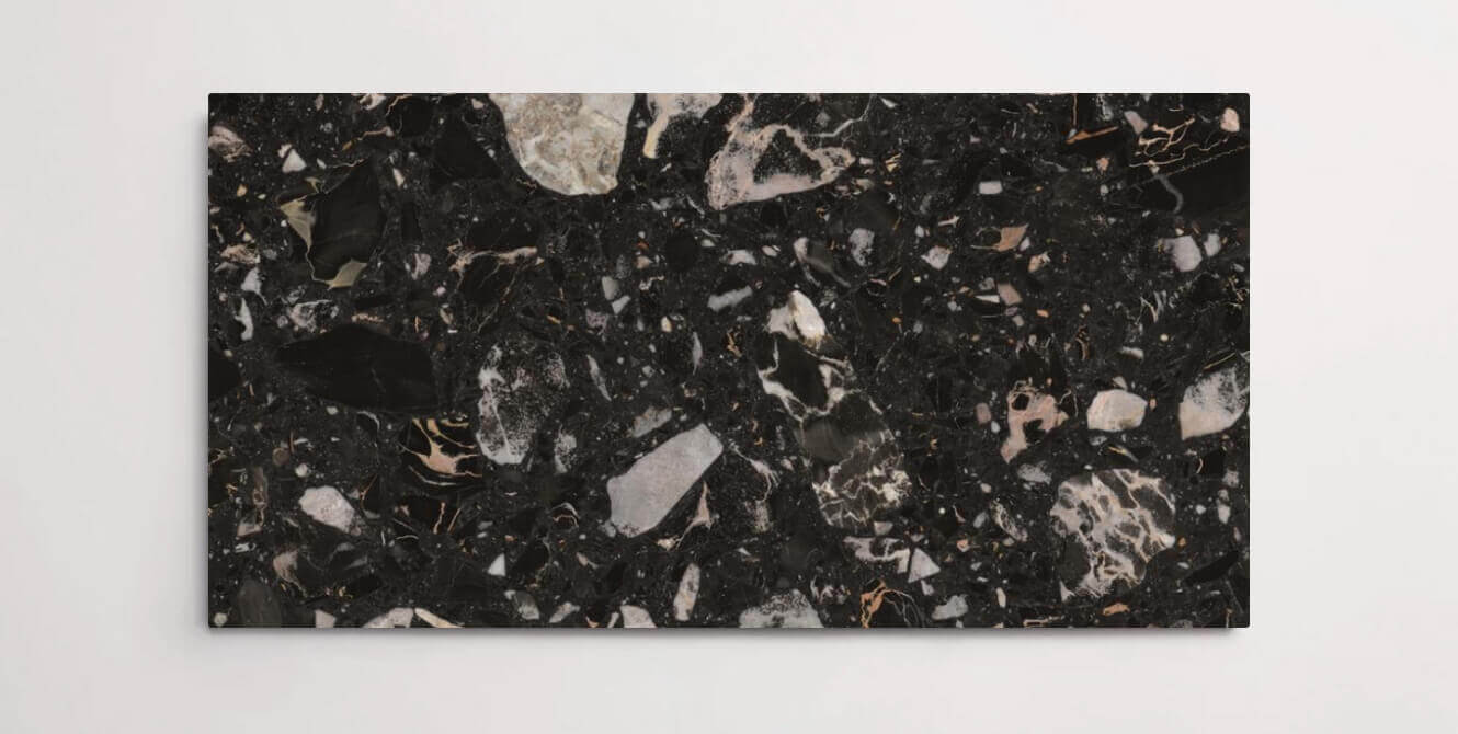 A single black terrazzo marble tile with various sized aggregates throughout