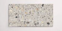 A single grey terrazzo marble tile with various sized aggregates throughout