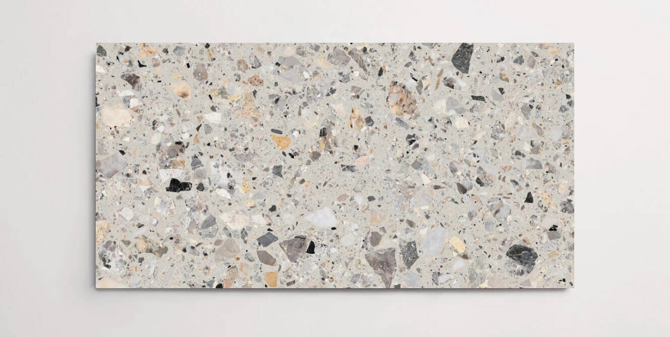 A single grey terrazzo marble tile with various sized aggregates throughout