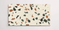 A single cream terrazzo marble tile with various sized multicolor chips throughout