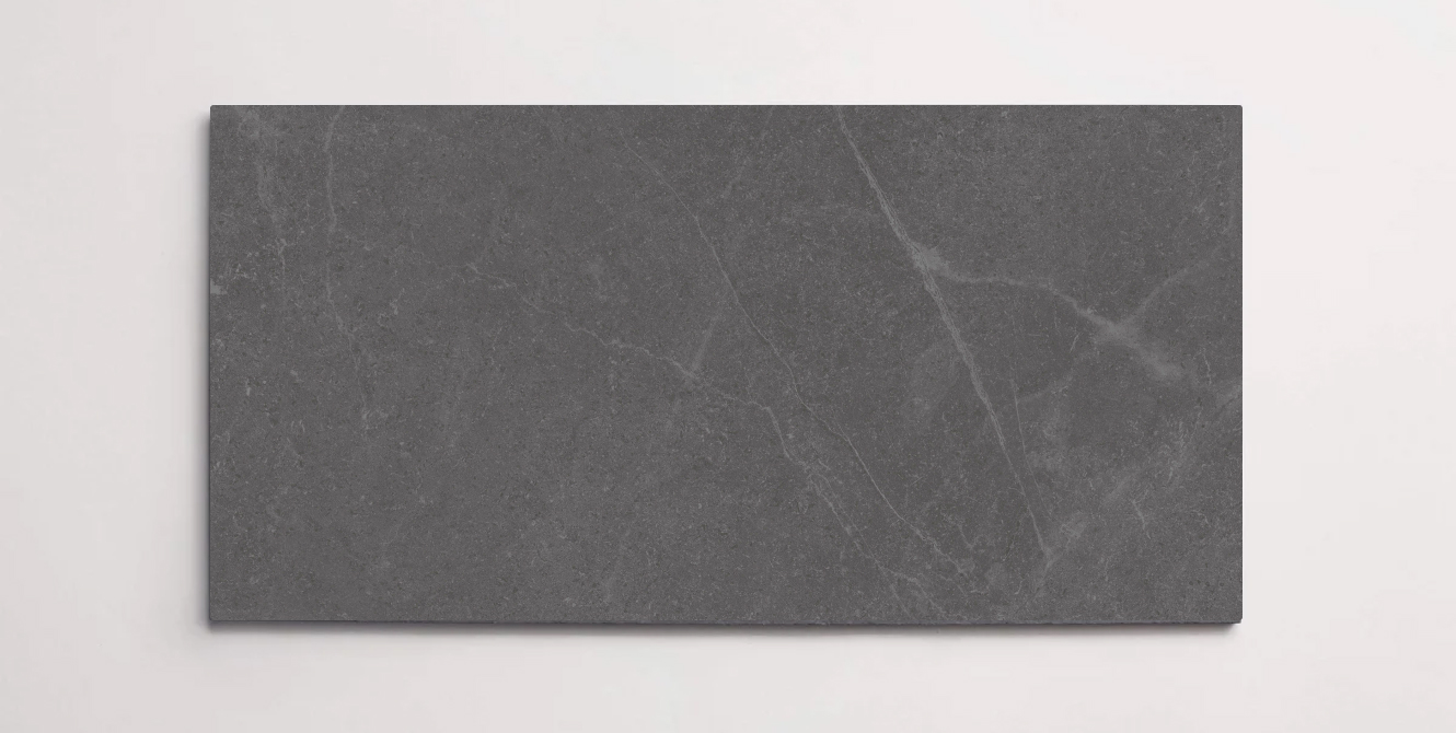 A single dark grey 10" x 30" stone-like porcelain tile with subtle veining