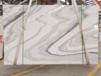 Calacatta blue wave marble slab with elegant blue grey veining and a polished surface.